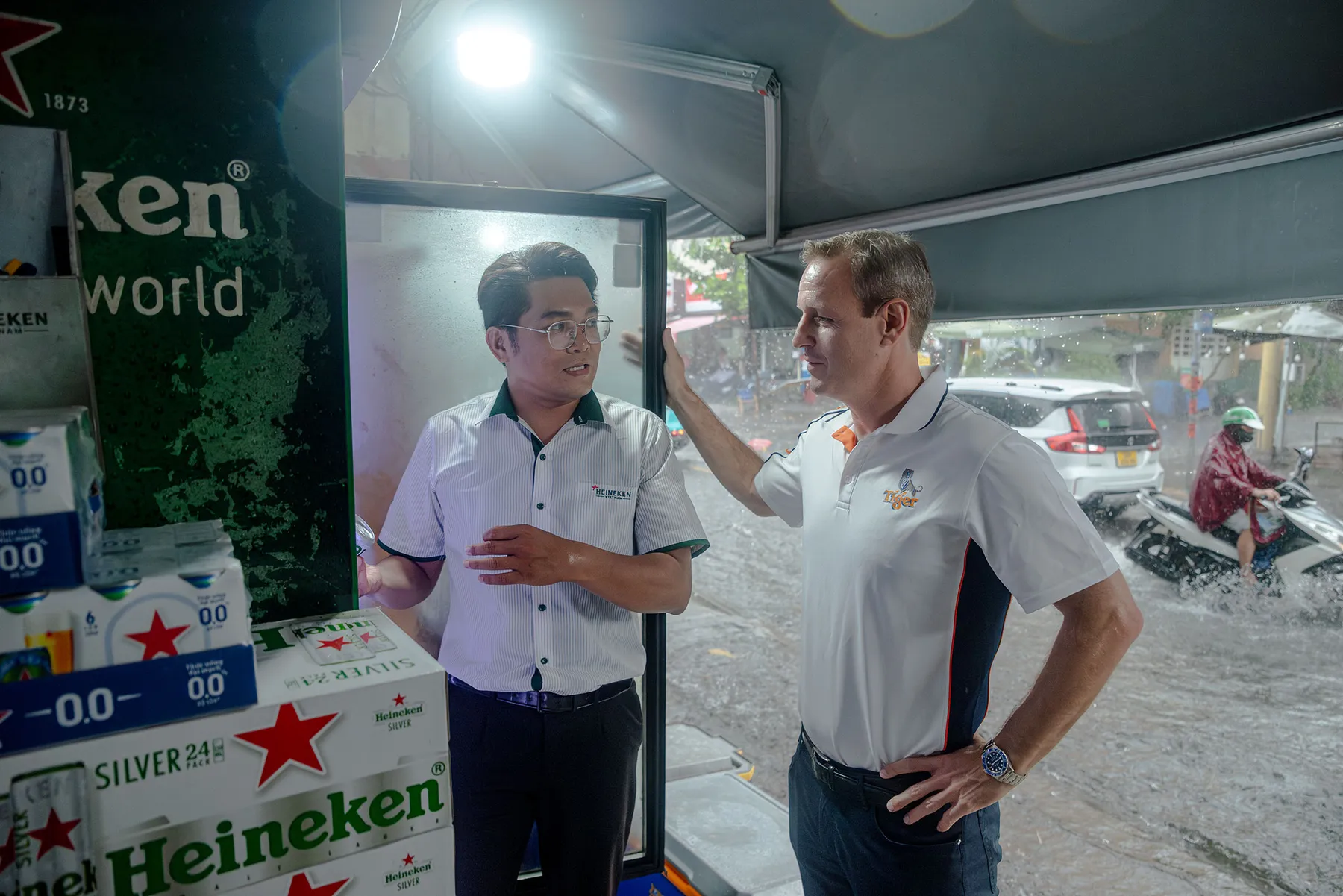 Mutters at Aunt Loc’s with Heineken sales rep Le Quoc Bao. hong Vo for Bloomberg Businessweek